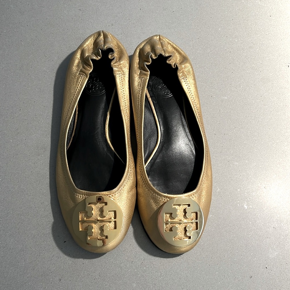 Gold Tory Burch flats.